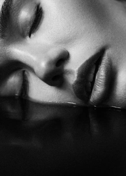 Beautiful emotional woman and her reflection. Black and white