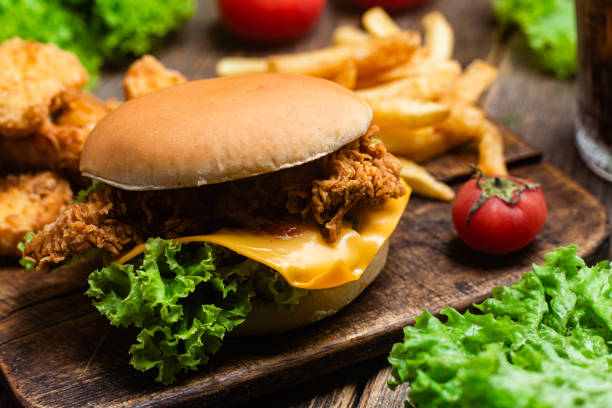 istock Cheeseburger, Potato, nuggets on a wooden board 1545689429