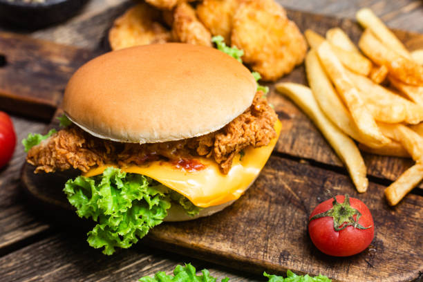 istock Cheeseburger, Potato, nuggets on a wooden board 1545690488