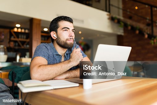 istock Pensive smart man thinking about her freelance work 1545695549