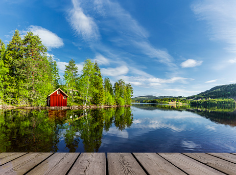 Red boathouse on a lake in Scandinavia