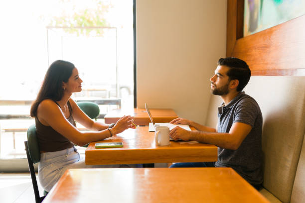 istock Young woman having a job interview at the cafe 1545697768