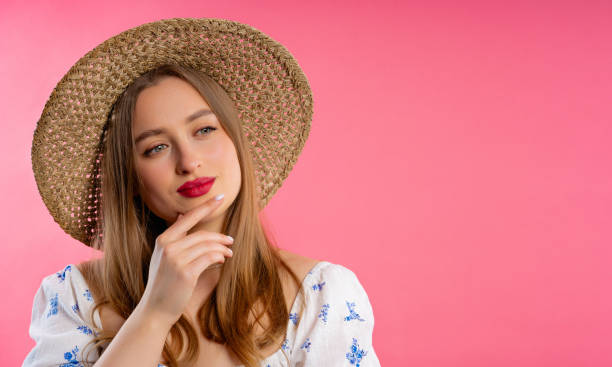 istock Thinking around woman on pink background. Puzzled lady looking answer.Copy space 1545703730