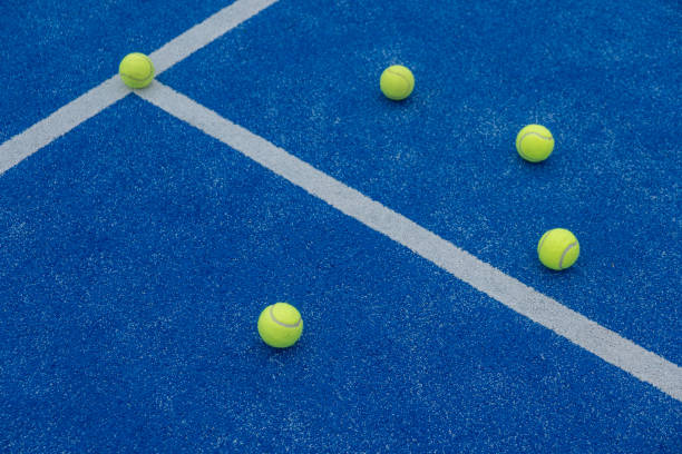 istock blue paddle tennis court with five balls 1545724022