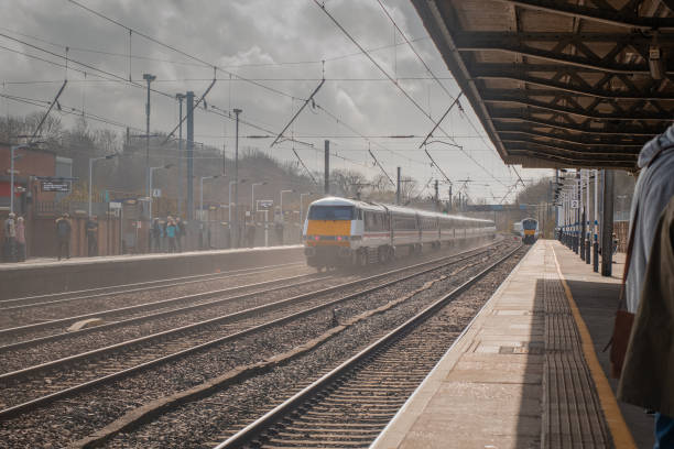 istock Fast and a conventional train on a Hitchin train station in engl 1545755178