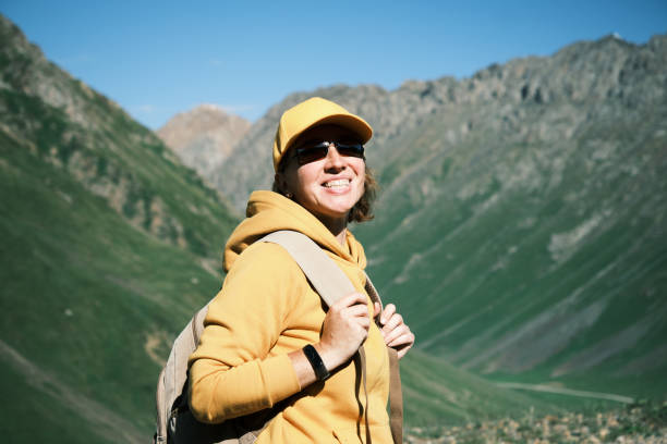 istock Female backpacker is walking on mountain pass 1545755394