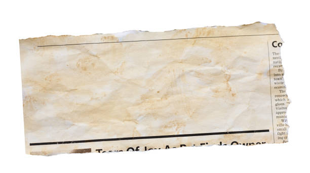 istock Wrinkled, stained newspaper clipping with blank space for your copy 1545757530