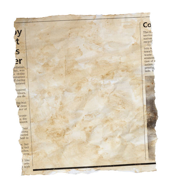 istock Wrinkled, stained newspaper clipping with blank space for your copy 1545757621