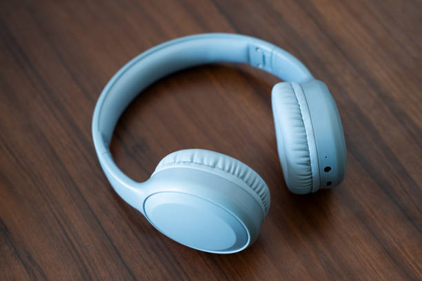 istock Blue headphone lay on wooden table 1545763254