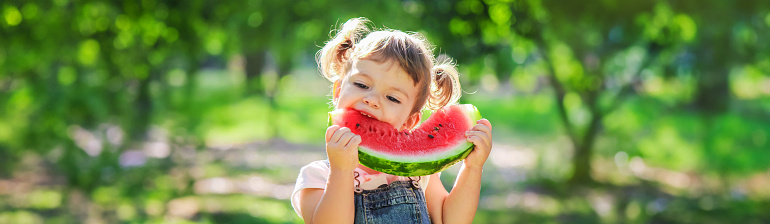 A child eats watermelon. Selective focus. Kid.