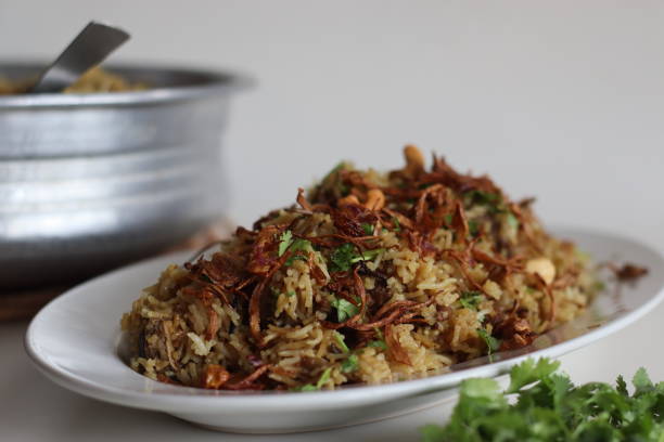 istock Mutton Biryani prepared with spices layered between mildly spiced ghee rice with a generous sprinkle of caramelized onions and Mutton marinated in yogurt 1545802568