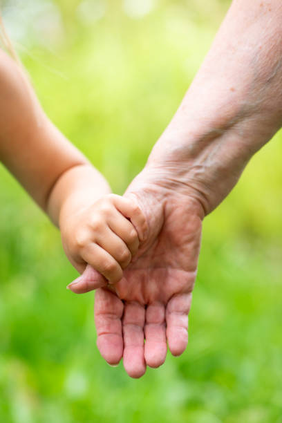 Parkinson disease patient, Alzheimer elderly senior, Arthritis person hand in support of nursing family caregiver care for disability awareness day, National care givers month, ageing society concept