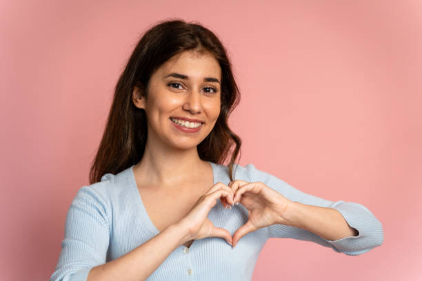 istock Woman shows heart shape with her hands. 1545810766