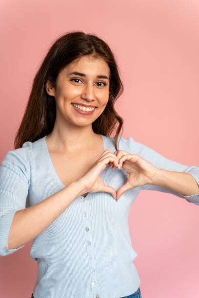 istock Woman shows heart shape with her hands. 1545811797