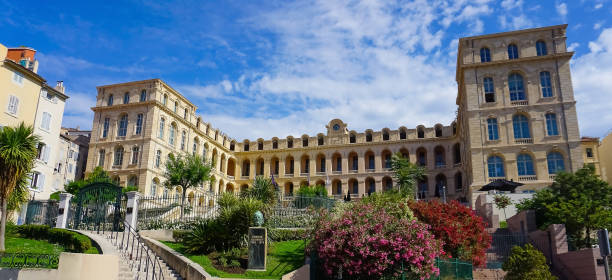 A statue of Honore Daumier artist is seen in front of Intercontinental Marseille The Hotel Dieu Marseille, France - May 29, 2023: A statue of Honore Daumier artist is seen in front of Intercontinental Marseille The Hotel Dieu in Panier district of Marseille, France marseille panier stock pictures, royalty-free photos & images