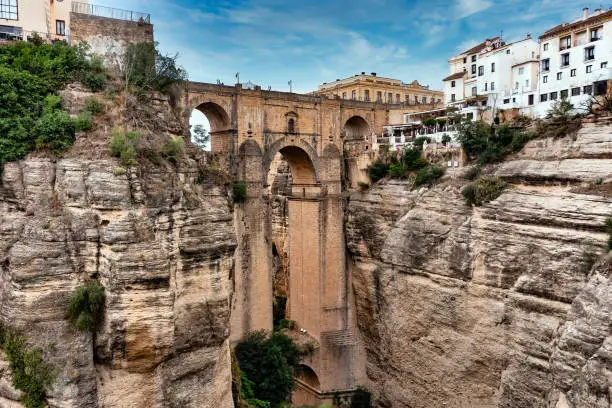 Puente Nuevo, Ronda's 'new bridge' was completed in 1793, after 40 years in construction and after the loss of the lives of 50 builders constructing the span bridging the 98m Tajo gorge. The bridge bisects Ronda into new town (mercadillo, 'little market') and old (La Ciudad).