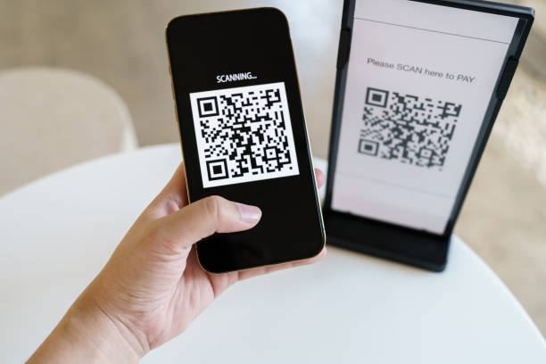 istock Qr code payment. E wallet. Man scanning tag accepted generate digital pay without money.scanning QR code online shopping cashless payment and verification technology concept. 1545828842