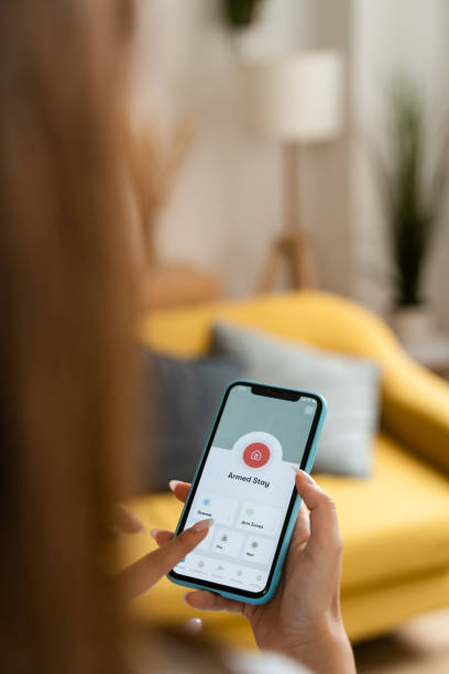 istock Woman holding a smart home screen display. 1545828851