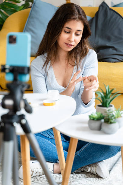 istock Female beauty streamer doing facial care tutorial. 1545849626