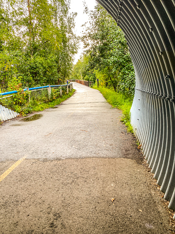 The park pathway leads through a culvert, allowing users to pass under a road.