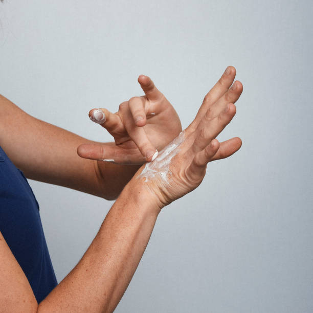 istock Woman hands applying white cream 1545895018