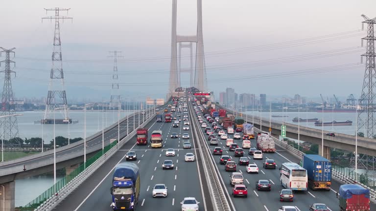 busy highway with lots of cars driving on the bridge