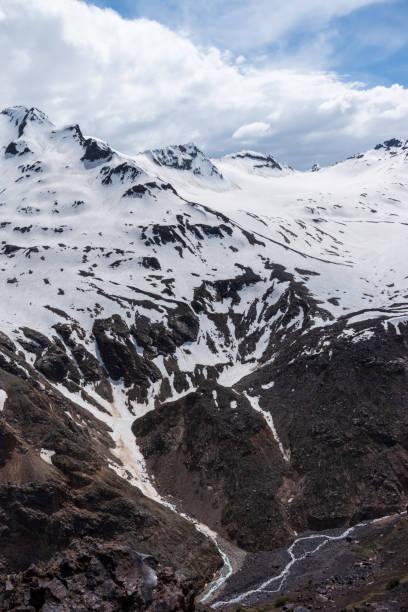 istock Black volcanic mountains in the snow 1545973874
