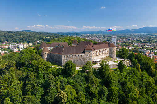 Ljubljana, Slovenia - June 27, 2020: Ljubljana Castle and old town in Slovenia. Ljubljana is the largest city. It's known for its university population and green spaces, including expansive Tivoli Park. The curving Ljubljanica River. Drone