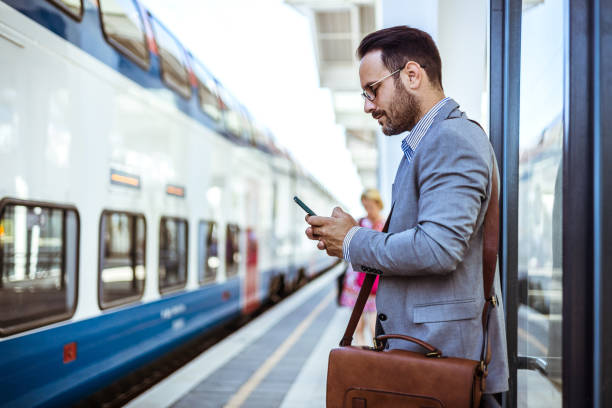 istock Young handsome businessman with smart phone in subway. 1546121243