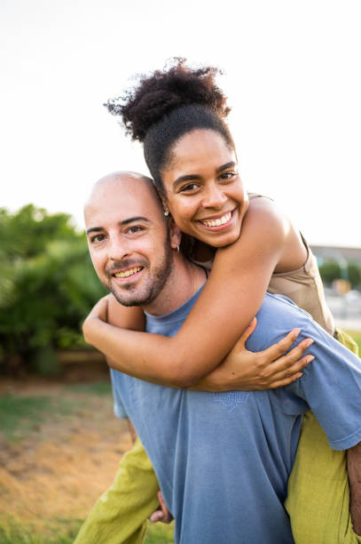 istock Two friends piggybacking on a park during sunset 1546155811