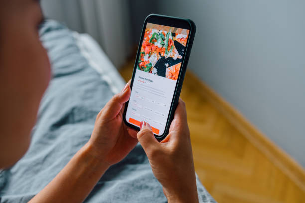 istock Anonymous Woman Lying on her Bed and Using a Smartphone to Order Something Online 1546278154