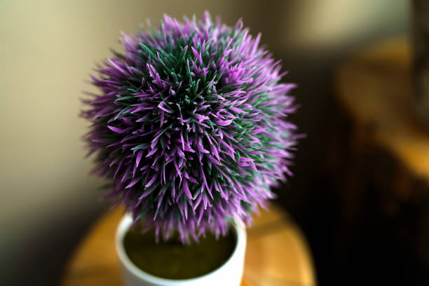 Beautiful artificial plant in flower pot on purple background, space for text