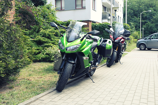 two sports motorcycle stands in the yard