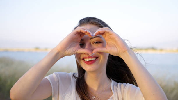 istock Woman making heart symbol with her hands 1546318165