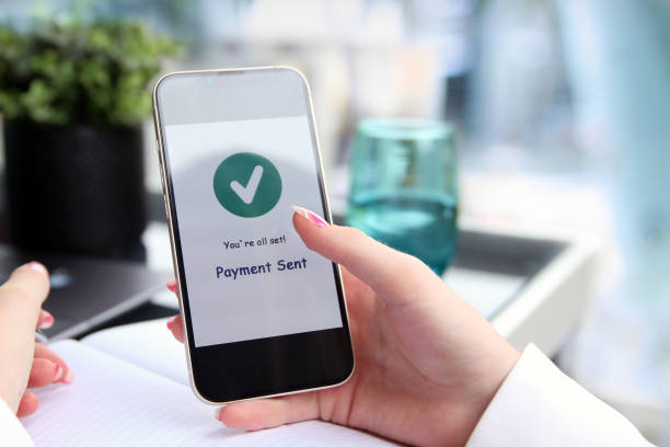istock Woman using online banking on mobile phone. Payment sent. 1546320280