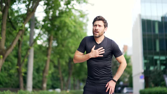 A man is running on a track when he suddenly starts to experience chest pain. He stops running and clutches his chest