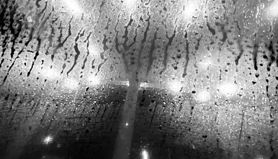 Wet front glass of a vehicle unique black and white photo