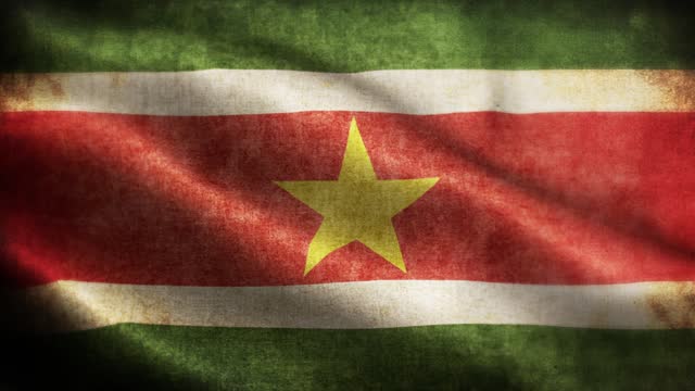 Closeup of grunge Suriname waving flag loopable stock video