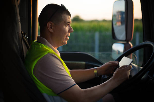 istock A man uses his smartphone while driving a truck. 1546428962
