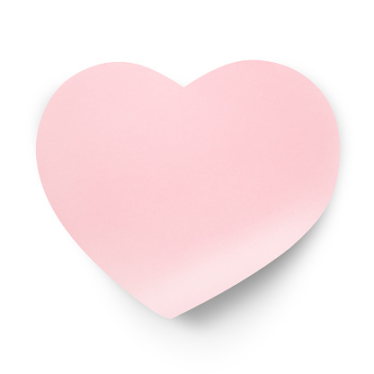 Paper sticky note in the shape of a heart isolated on a white background.