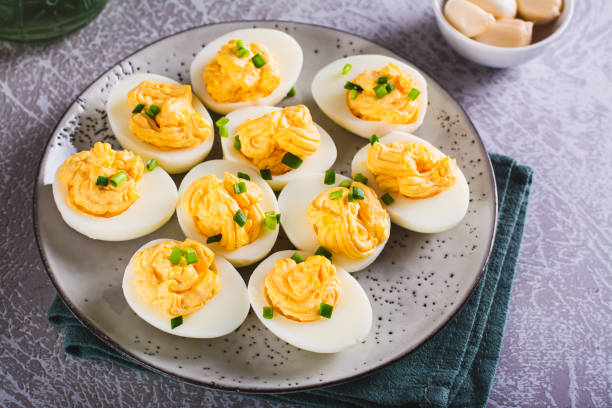 istock Boiled eggs stuffed with yolk, cheese, garlic and mayonnaise on a plate 1546442256