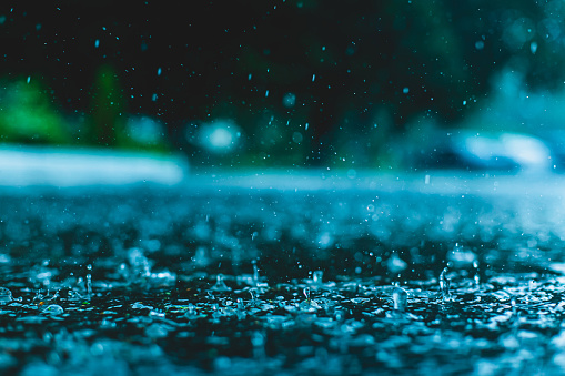 Splashes of rain on a puddle.