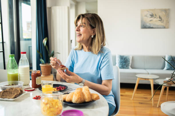istock Happy mature woman is having breakfast 1546750998
