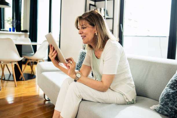 istock Shot of a mature woman using her digital tablet 1546751551