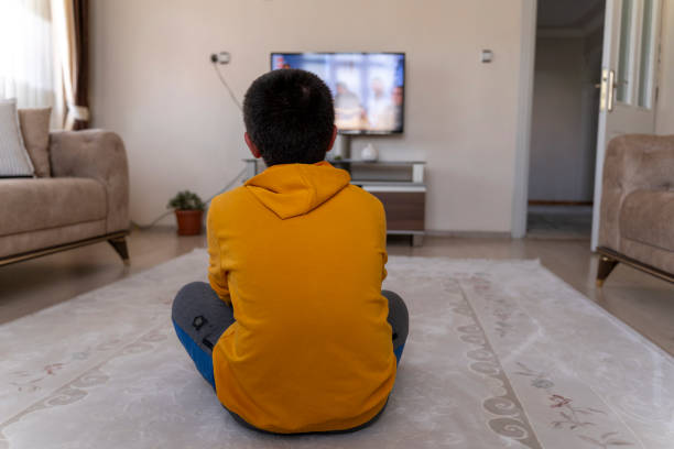 istock Boy watching TV at home. 1546780243