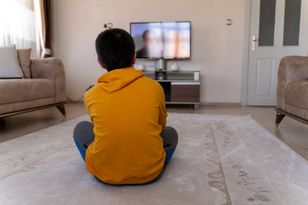 istock Boy watching TV at home. 1546782266