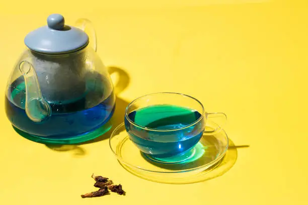 Photo of Blue tea or Butterfly tea on yellow background, popular Asian caffeine free herbal drink for health and detox