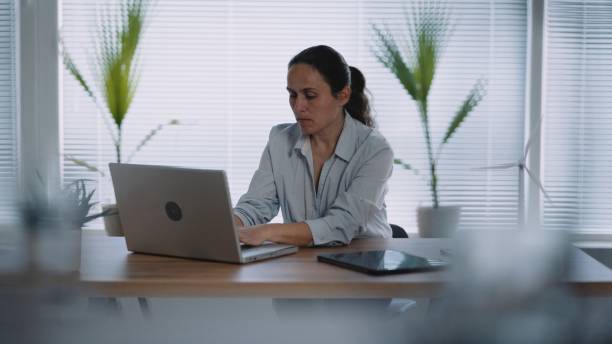 istock Businesswoman working in office. 1546811639