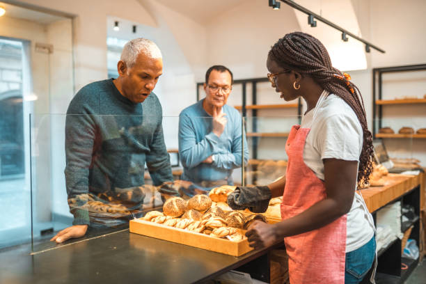 istock Black Female Offering Freshly Baked Bread At An Artisan Bakery 1546822249