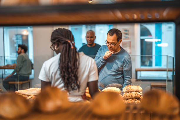 istock Black Female Offering Freshly Baked Bread At An Artisan Bakery 1546822393